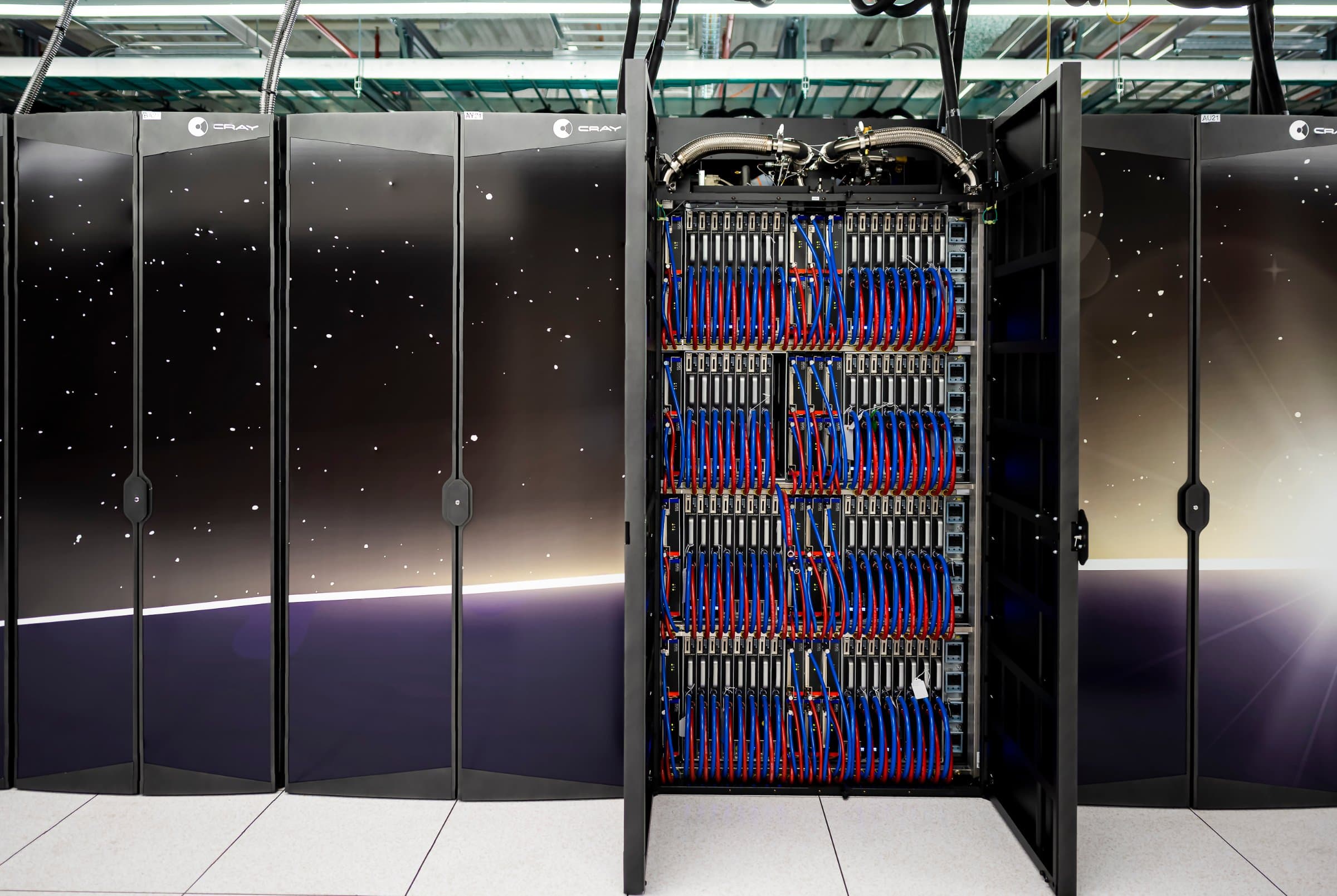 Open cabinet of the Frontier supercomputer showing dense compute blades and cabling