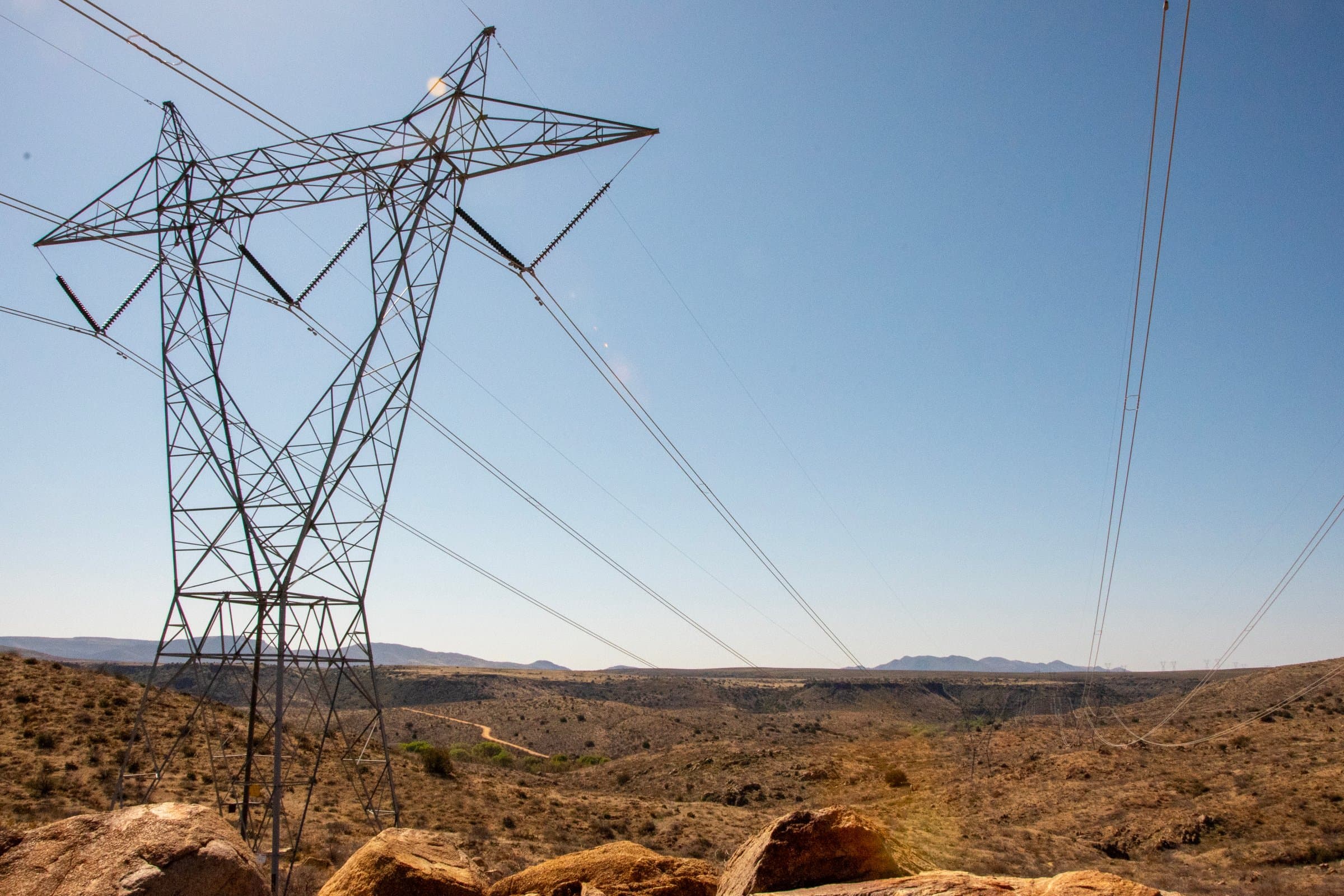 High-voltage transmission tower and lines crossing the Arizona desert